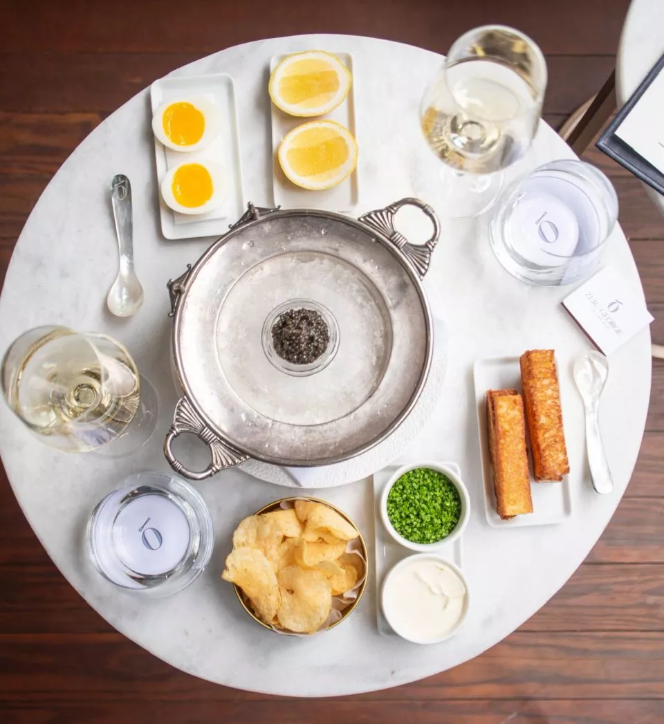 Caviar bar setting with eggs, chips, lemon, wine